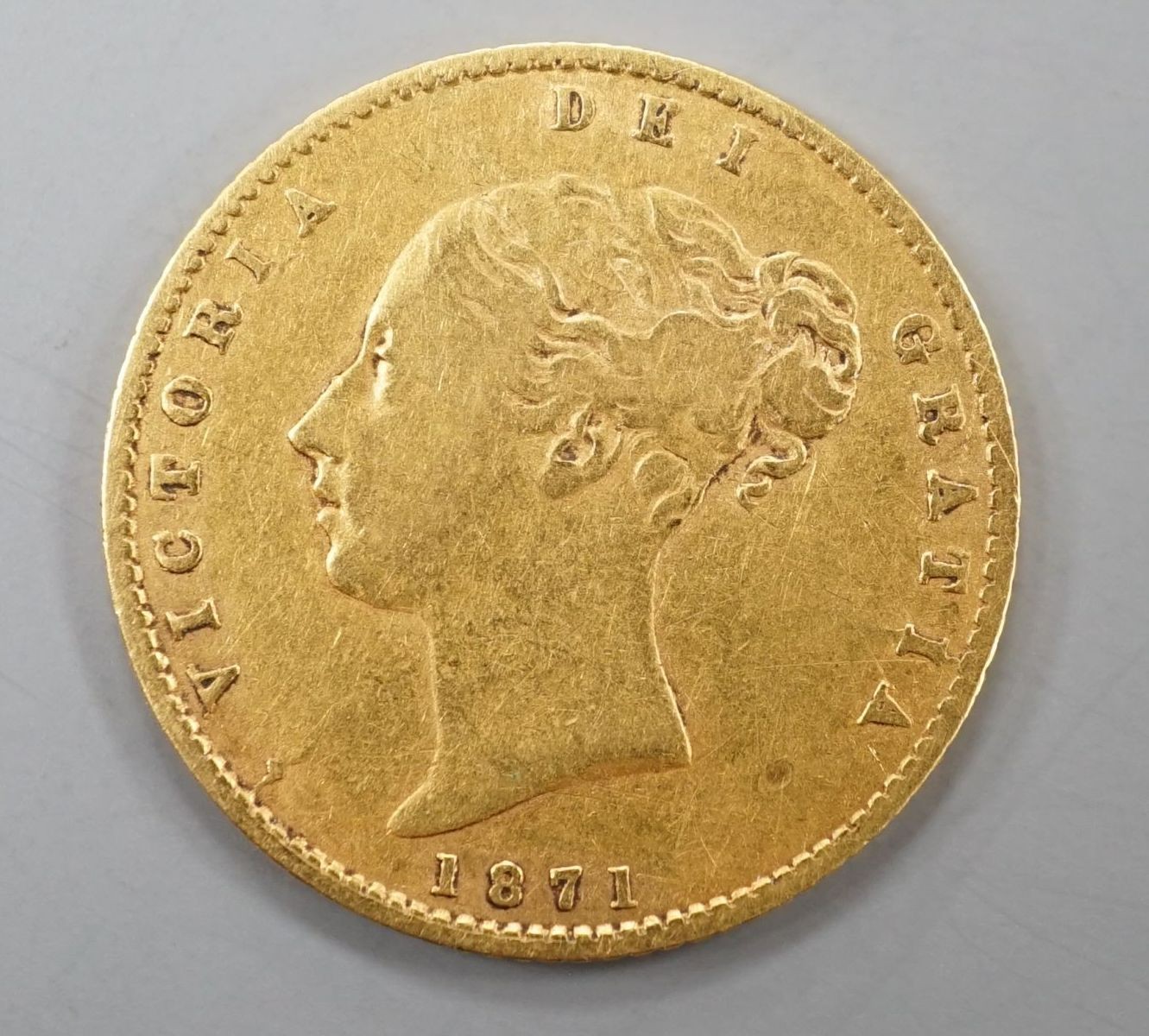 A Victorian 1871 gold shield back half sovereign, London Mint.